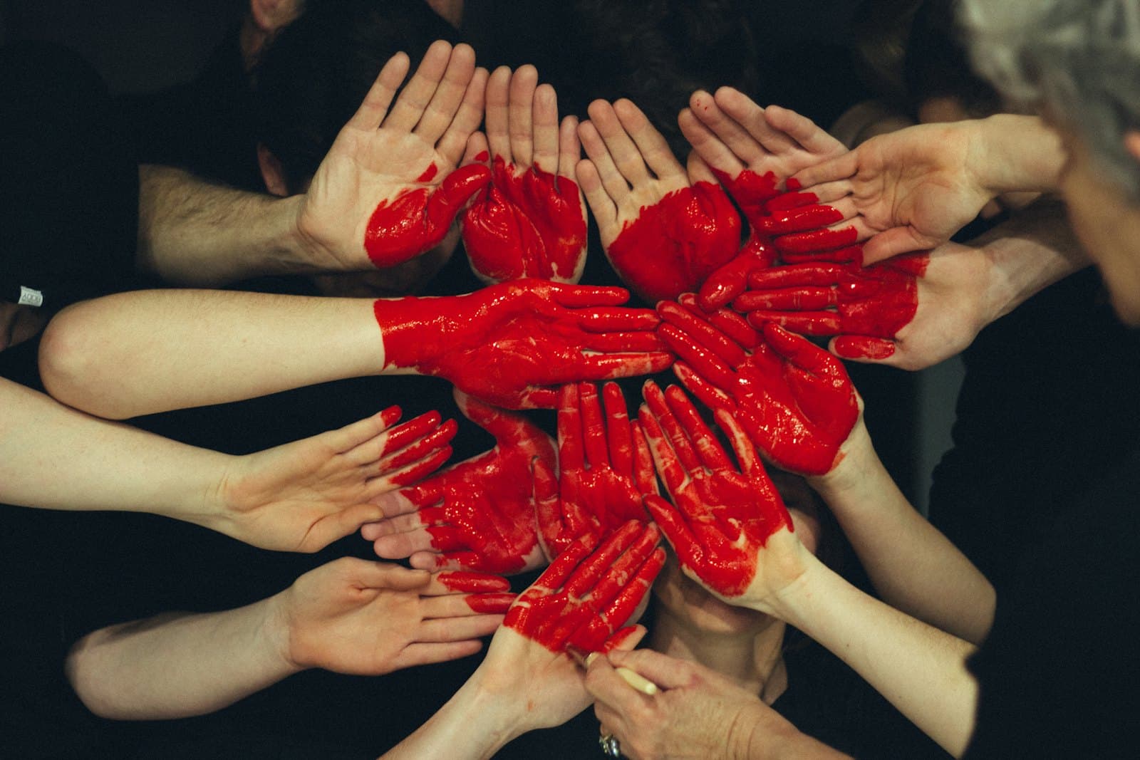 Women and volunteers joining hands in support and unity
