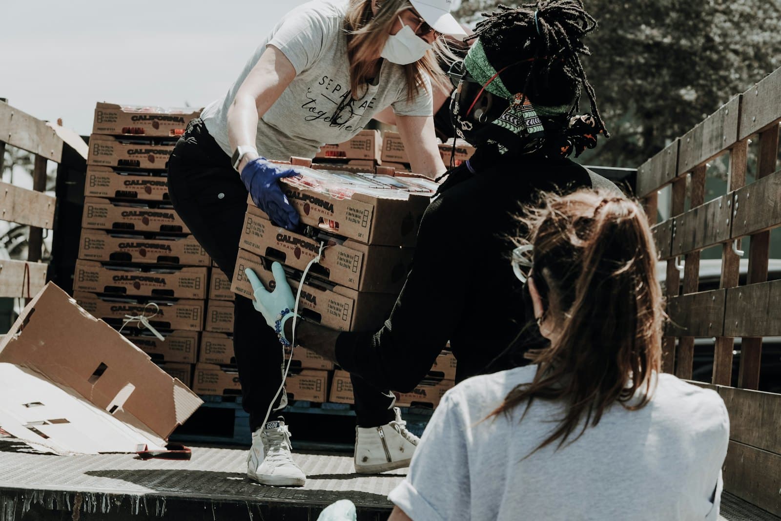 A helper handing a donation to a woman in need